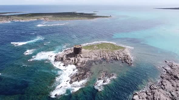 great bird's eye view of the breathtaking little island with a tower of stintino in sardinia, nice w