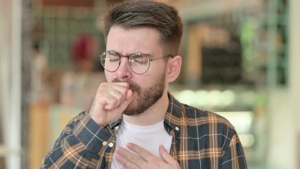 Portrait of Sick Young Man Coughing