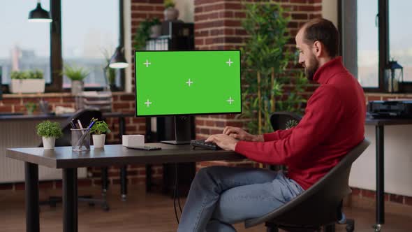 Financial Analyst Working with Green Screen on Computer