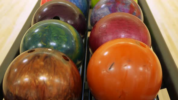 Row Of Ten Pin Bowling Balls Lined Up In A Rack