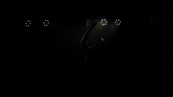 Silhouette of Girl on Pole in a Smokefilled Room