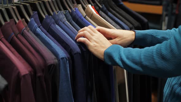 Man Choosing Shirt at Clothing Store