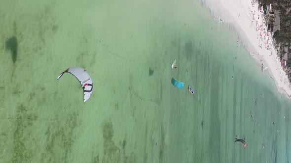 Vertical Video Kitesurfing Near the Shore of Zanzibar Tanzania Aerial View