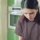 Young Caucasian Woman in Brown Tshirt Cooking at Home Kitchen - VideoHive Item for Sale