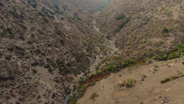 Aerial drone shot descending on river between mountains-4K