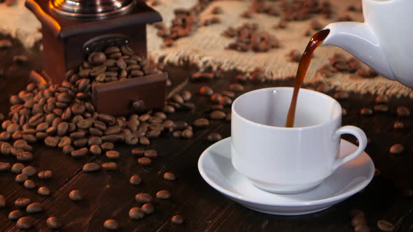 Black Hot Coffee Poured Into White Cup From Coffee Pot