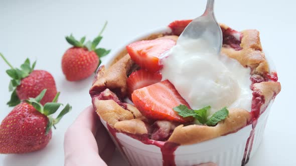 Strawberry cobbler pie with ice cream.