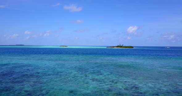 Beautiful flying island view of a white sandy paradise beach and blue ocean background in vibrant 4K