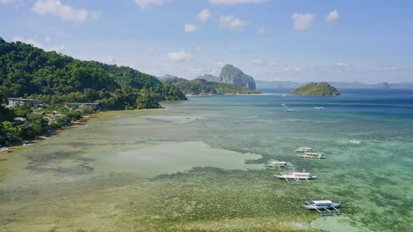 El Nido Palawan Island Philippines Aerial Drone View of Boats Anchored in the Bay with Clear Emerald