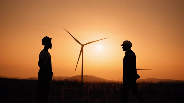 Silhouette African American Man in White Helmet and Black Suit Shaking Hands