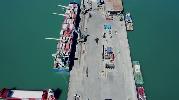 Aerial top view of cargo ship standing in the port