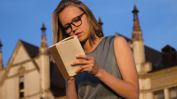 Hipster girl writing something in her notebook