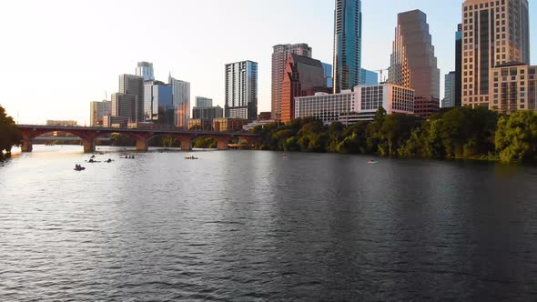 Low drone shot of ladybird lake and downtown austin texas. Drone slowly moves towards a group of kay