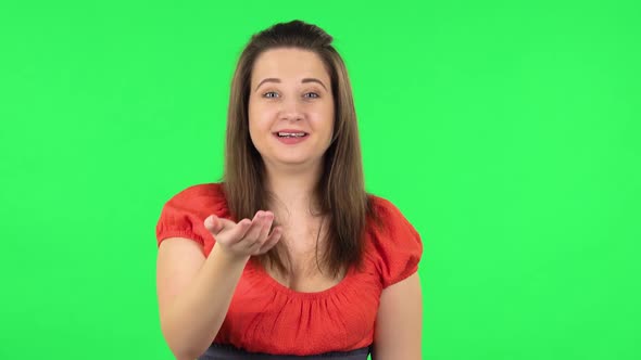 Portrait of Cute Girl Waving Hand and Showing Gesture Come Here. Green Screen