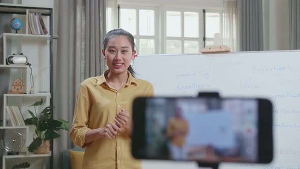 Asian Female Teacher Shoots Video By Smartphone Camera While Teaching English At Home