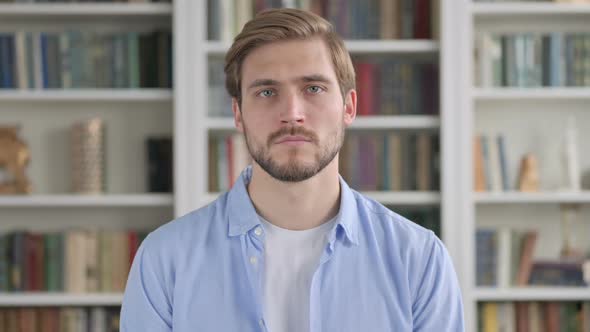 Portrait of Serious Man Looking at the Camera