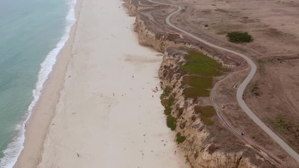 AERIAL: drone, half moon bay beach cliffs and shore, flying forward view