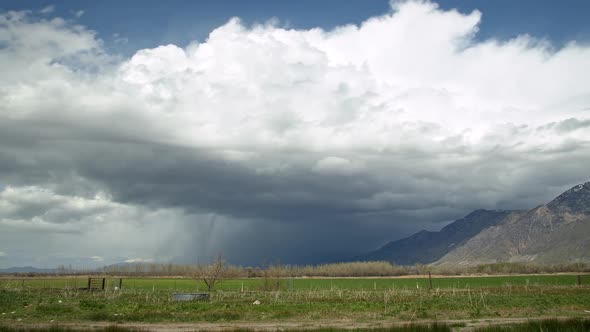 Time lapse of storm moving over the landscape against the mountains