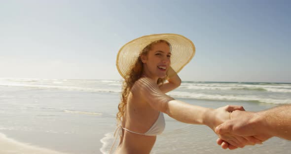 Couple having fun at beach on a sunny day 4k