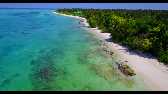 Aerial view seascape of idyllic seashore beach break by blue lagoon with white sandy background of a