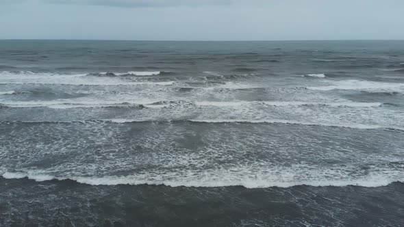 storm waves in the ocean in cloudy weather