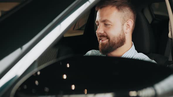 Man Looking at a Car in a Car Showroom