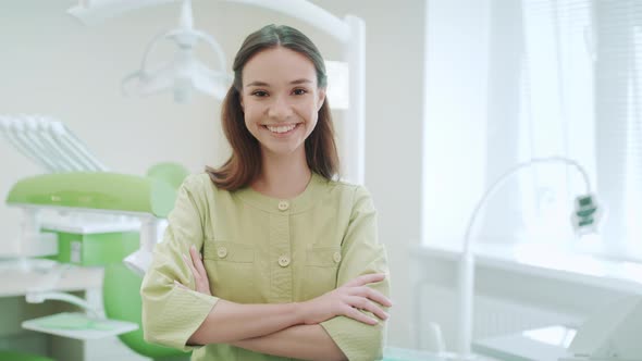 Smiling Dentist in Dental Clinic Interior. Portrait of Woman Dentist