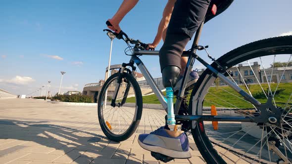 A Bike Is Being Ridden By a Person with a Prosthetic Leg