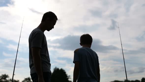 Happy Father and Son Enjoying Fishing Together