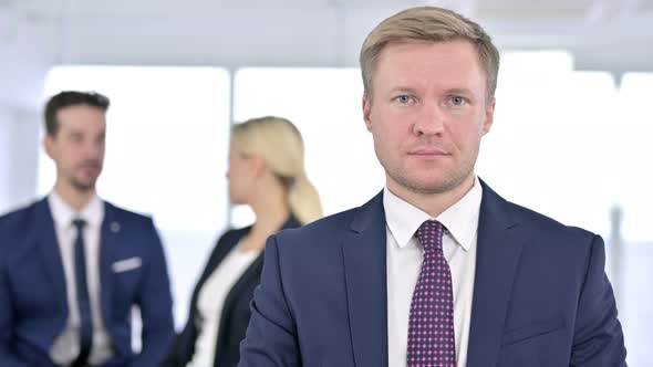 Portrait of Serious Businessman Looking at the Camera in Office