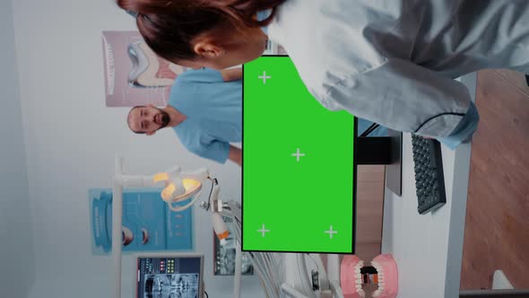 Vertical Video Dentist Working with Horizontal Green Screen