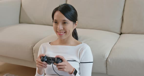 Woman play tv game at home