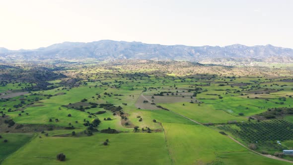 Aerial approach towards Kyrenia mountains over countryside, Cyprus