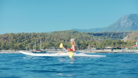 Girl In Kayak Summer Trip. Woman Exploring Calm Sea By Canoe On Holiday Vacation Weekend. Kayaking