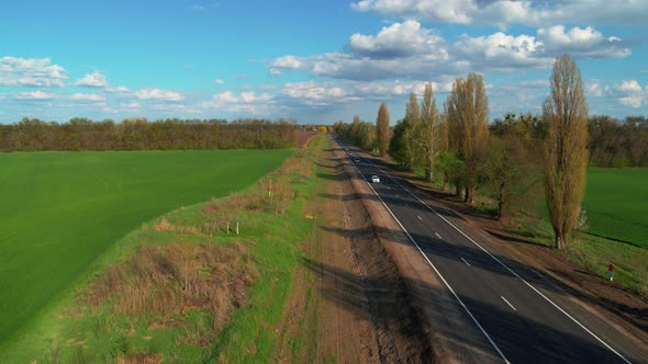 New Road Through Countryside and Cultivated Field Aerial View