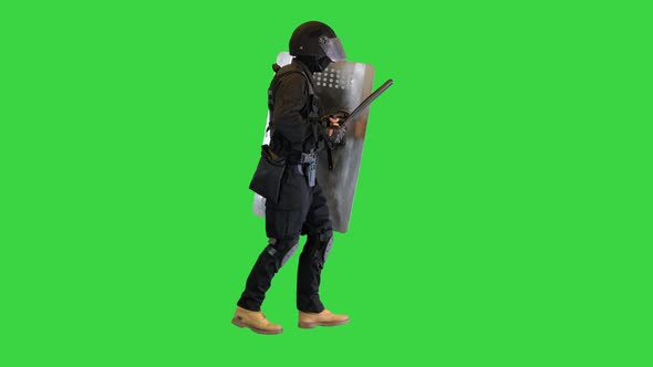 Policeman in Full Uniform Running with a Shield and Baton on a Green Screen Chroma Key