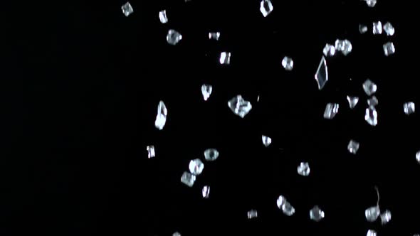 Precious Stones Falling on the Floor in a Dark Room. Black Background. Slow Motion