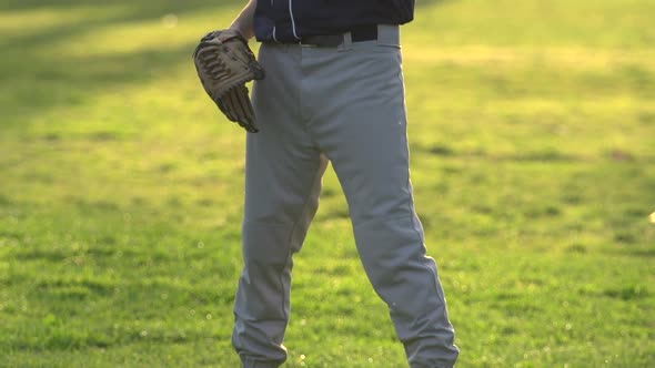 A young man playing catch with a baseball.