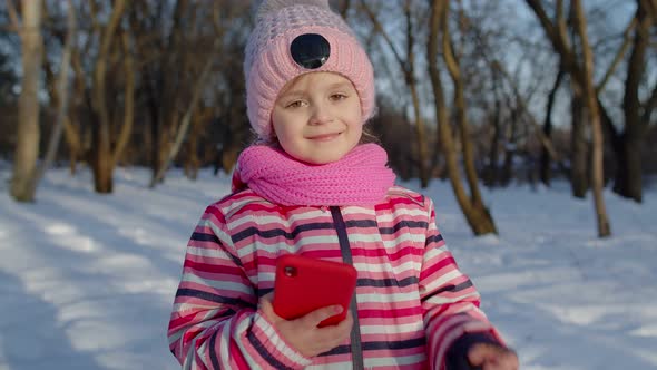 Children Kid Tourist Blogger Browsing on Mobile Phone Publishing New Photo Post on Social Media