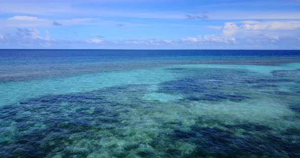 Daytime birds eye island view of a summer white paradise sand beach and blue sea background 