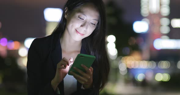 Business woman cellphone at night 