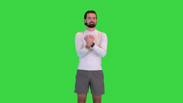 Man Stretching Forearm Before Exercising on a Green Screen Chroma Key