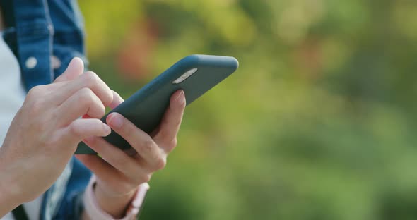 Woman Use of Mobile Phone Over Green Background