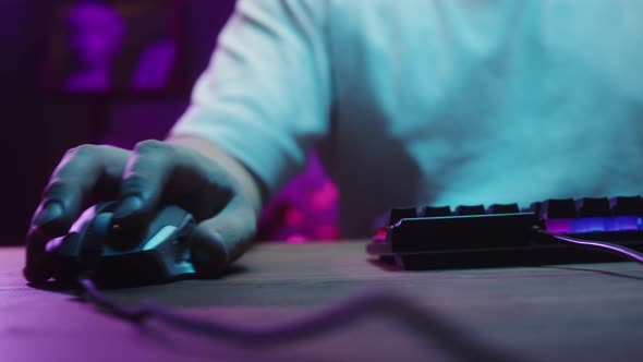 Gamer Typing on Backlight Keyboard Closeup Man Playing Video Game