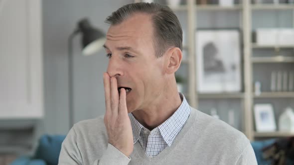 Portrait of Tired Middle Aged Man Yawning