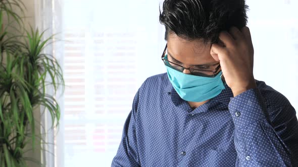 A Young Businessman with Protective Mask in Face Feeling Sick 