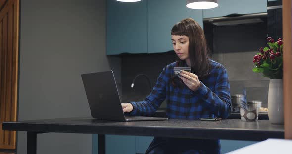 The Girl Enters the Details of a Bank Plastic Card for Online Purchases