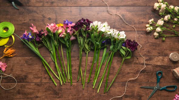 Creation of Bouquet From Flowers with Different Colours Wooden Background Stop Motion Animation