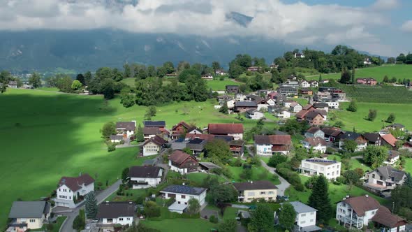 Aerial View of Liechtenstein with Houses on Green Fields in Alps Mountain Valley