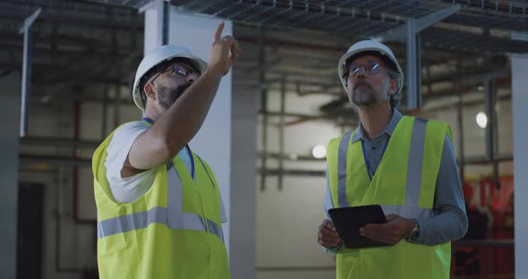 Employees Discussing Power Station Workshop